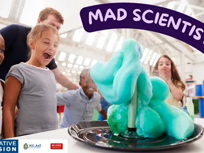Children watching blue foam eruption experiment, banner reading "MAD SCIENTIST DAY"