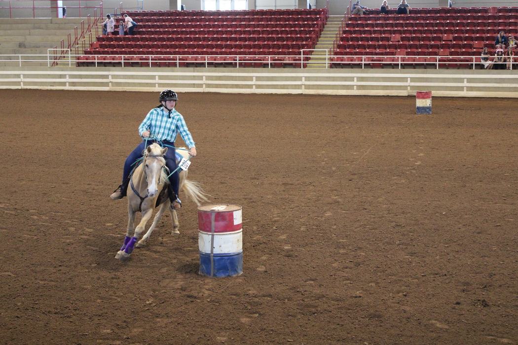 Lindsay Church rounds her second barrel during competition on horse Fabio during the West District 4-H Horse Show on April 30, 2022.