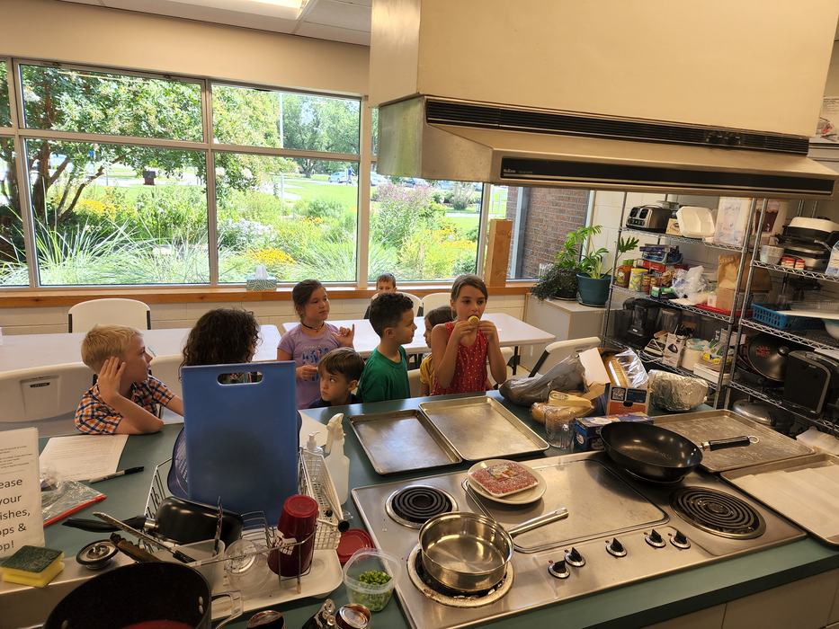 A group of children in a kitchen.