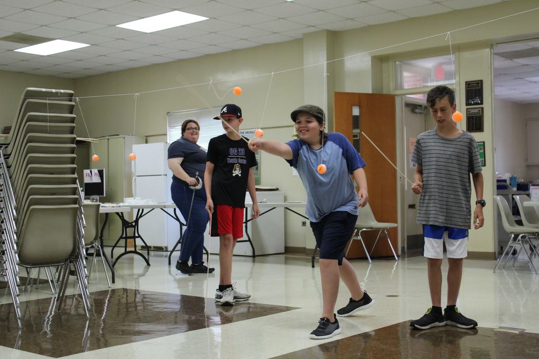 Kids learning about sword play.