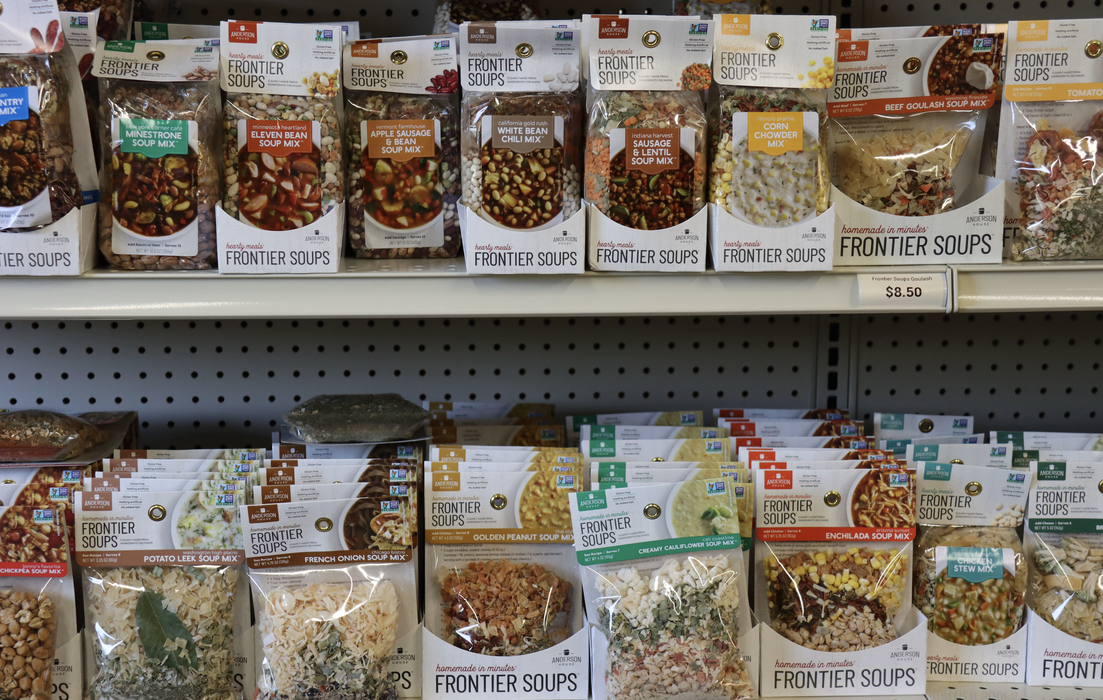 Packs of preserved food on shelves.