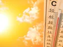 Thermometer reading about 40°C beside bright sun and orange sky