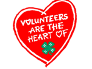 Red heart graphic with text "VOLUNTEERS ARE THE HEART OF" and a small green four-leaf clover
