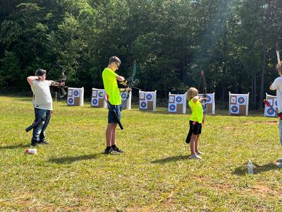 Three Caldwell County archers, Elijah Dillon, Jaxson Price and Cora Baker shoot at the West Regional 4-H Shooting Sports Tournament on August 13 in Polk County, NC.