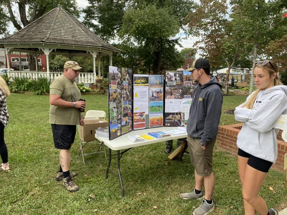 people reading an educational display