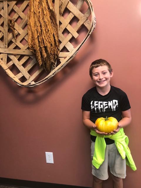 Youth showing off his giant tomato