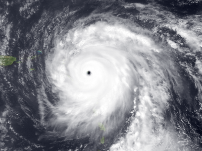 Satellite view of a large hurricane with a clear eye near small Caribbean islands