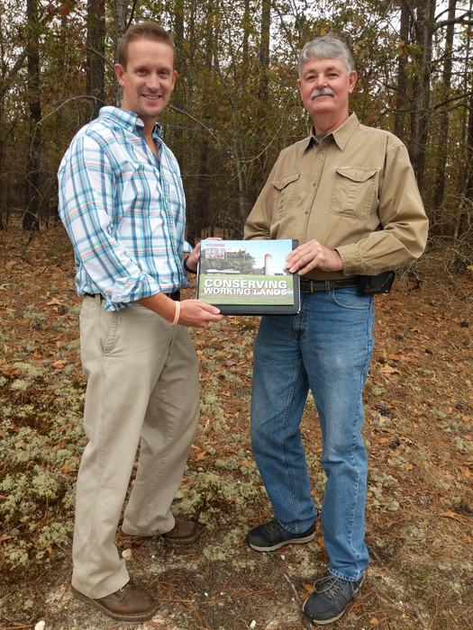 two men holding a publication