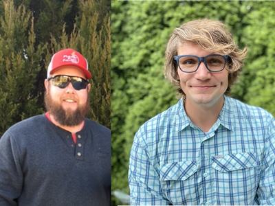 Two men by shrubs—left with red cap, sunglasses and beard; right with blue glasses and plaid shirt