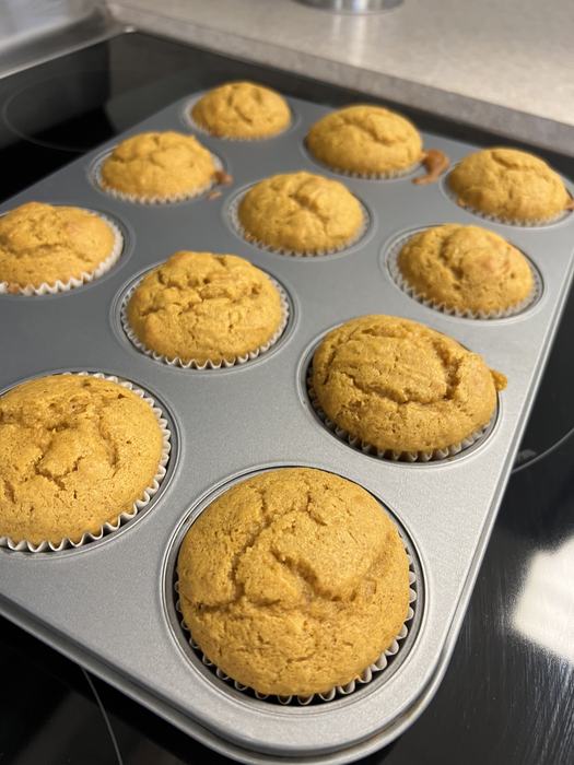 Baked pumpkin bread muffins in a tin.