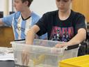Will Perry works to ballast his ocean robot model during 4-H STEM Night on October 13 at CCC&TI. Ballasting involves adding or removing weights to vessels to change their buoyancy.
