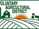 Text "VOLUNTARY AGRICULTURAL DISTRICT" with barn, silo, rising sun, tractor over cultivated fields