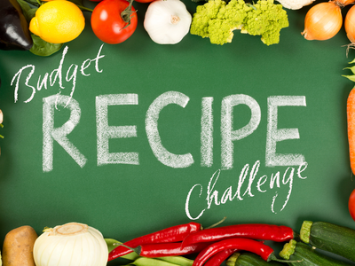 Chalkboard reading "Budget RECIPE Challenge" bordered by assorted fresh vegetables