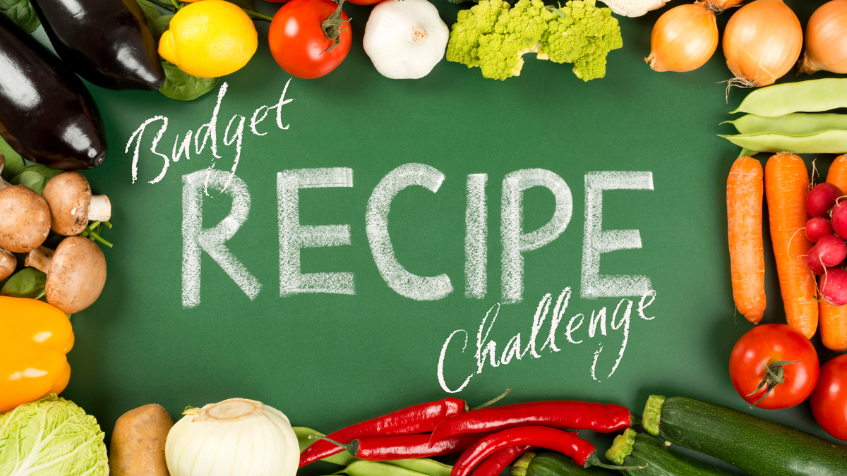 Chalkboard reading "Budget RECIPE Challenge" bordered by assorted fresh vegetables