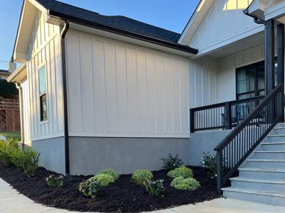 A white house with mulched landscape
