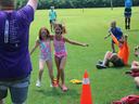color game participants race toward the finish line as the other campers go wild cheering them on