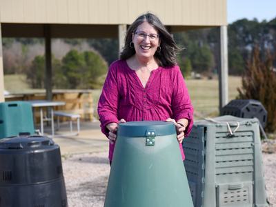 Rhonda Sherman with composting barrels