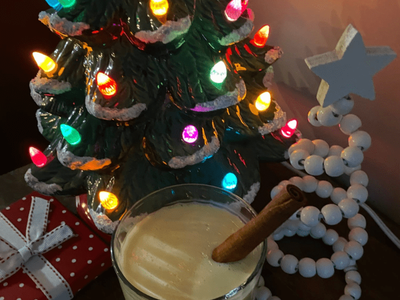 Decorative Christmas trees with mug of egg nog