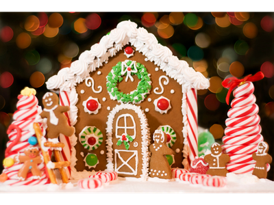 Gingerbread house with icing wreath, candy canes, peppermint candies, and gingerbread figures