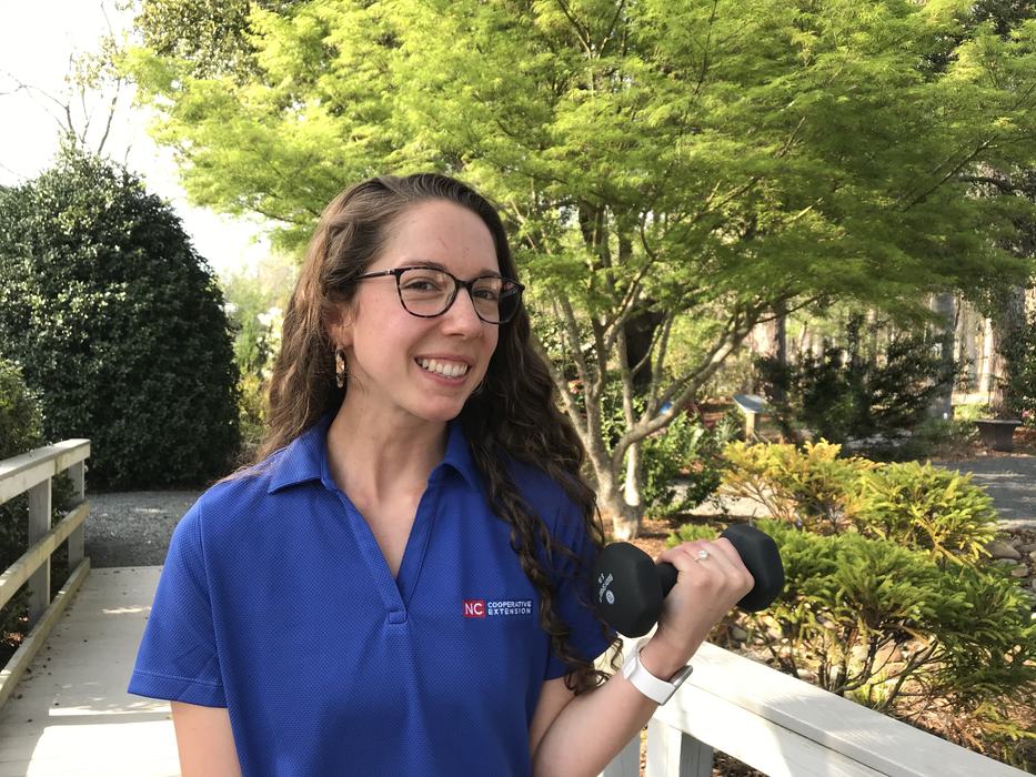 Headshot of FCS Agent Rachel Ezzell holding dumbbell