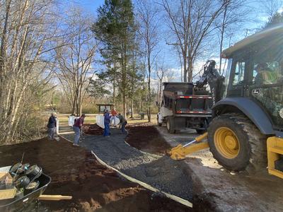 The Caldwell County Master Gardener Association and the street division for the City of Lenoir installing plants and gravel paths.