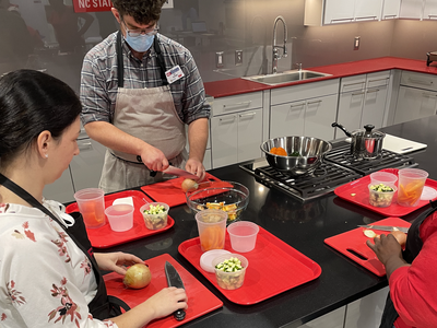 Staff practicing knife skills
