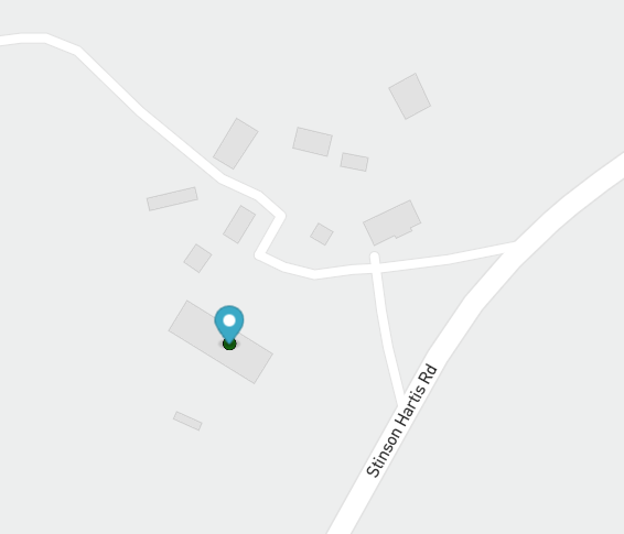 An overhead map with a blue pin over a structure.