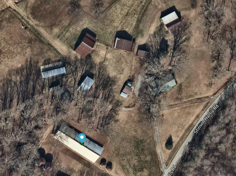 An overhead satellite map with a blue pin.