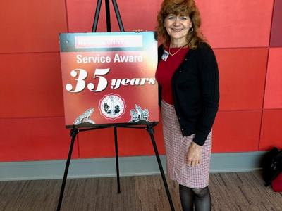 A woman poses with a 35 year Service Award