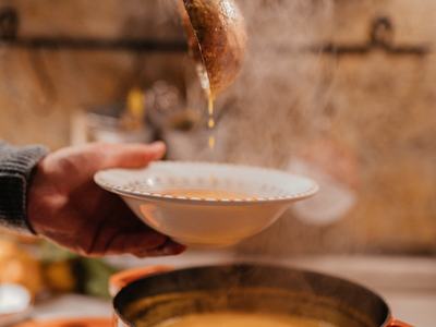 Serving Soup in a bowl from the hot pot on the stove