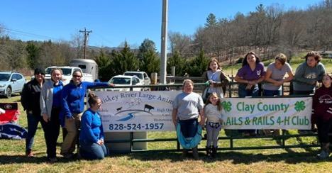 Club members standing by their club sign