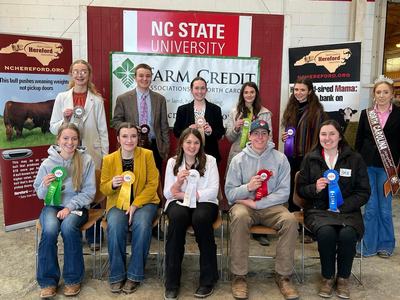 A group of award winners holding their ribbons.