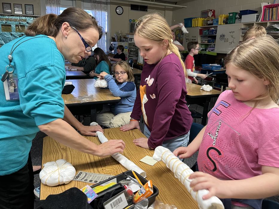 Pam Walker of the Bear Paws 4-H Club helps youth with their tie dye projects.