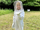Junior beekeeper in bee suit