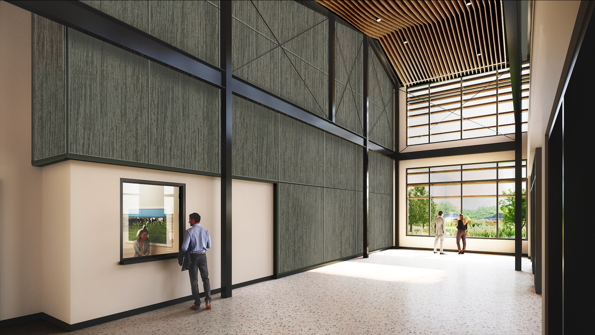 green wall, windows, man standing at a sliding glass window talking with a woman