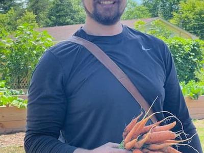 Zac holding carrots from garden