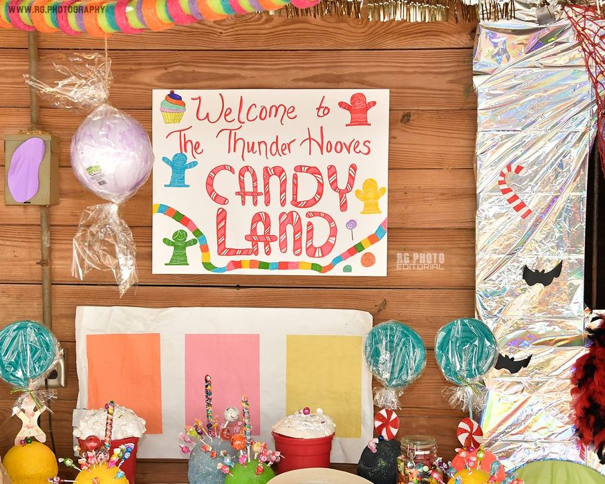 Sign reading "Welcome to The Thunder Hooves CANDY LAND" above a candy-decorated display