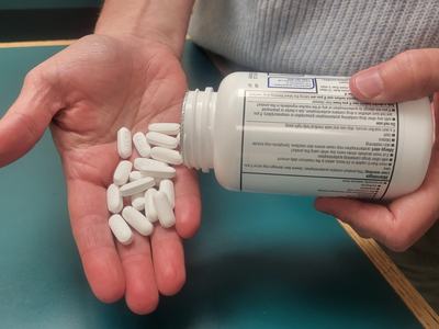 pouring pills out of bottle into open palm