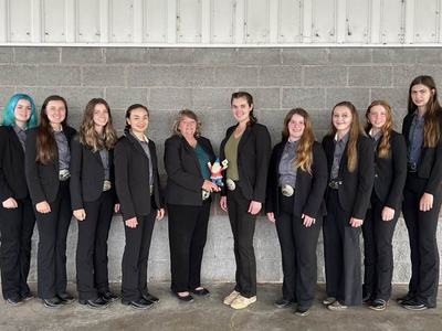 A young woman receives an award.
