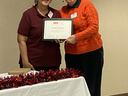 Two women holding framed certificate reading "SHERRY JORDAN" "MASTER GARDENER OF THE YEAR"
