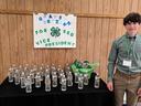 White male teen in green shirt campaigns for district office