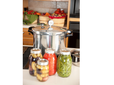 canner with canned foods in front it