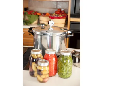 canner with canned foods in front it