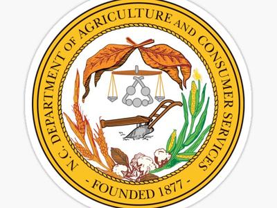 N.C. Department of Agriculture and Consumer Services seal, Founded 1877, plow, scales, crops