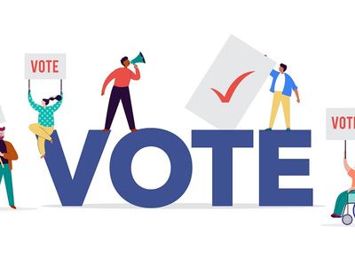 People holding "VOTE" and checkmark signs around large blue letters VOTE