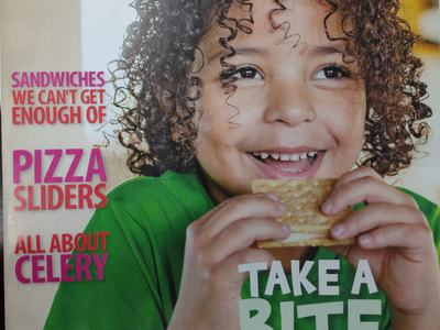 Curly-haired child holding a sandwich; magazine title "CHOP CHOP" and text "TAKE A BITE OUT OF SPRING"