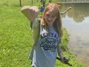 girl holding a fish she caught