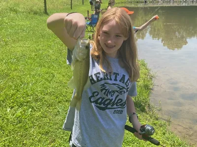 girl holding a fish she caught