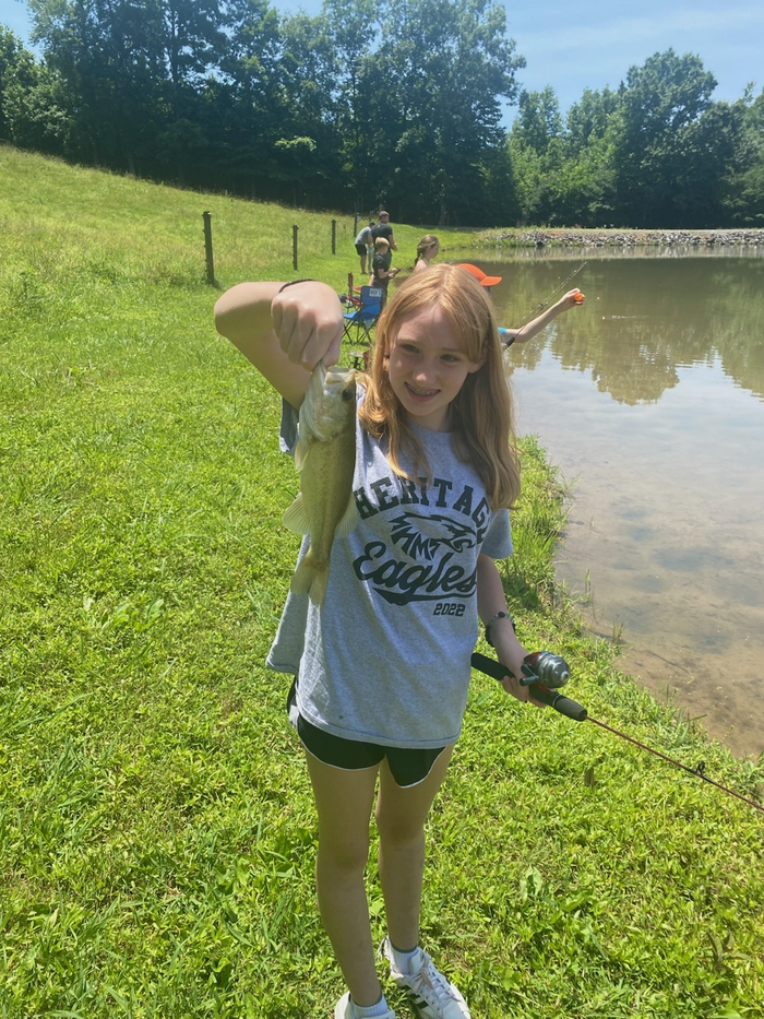 girl holding a fish she caught