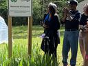 Tarleton & Bonnie Davis Memorial 4-H Garden sign with people standing beside it